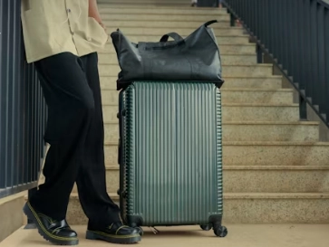 person with luggage on stairs