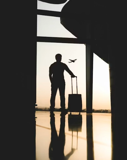 man holding luggage inside airport